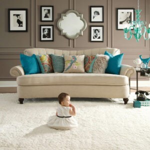 Cute baby sitting on carpet floor | Carpetland USA