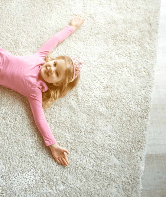 Cute girl laying on rug | Carpetland USA